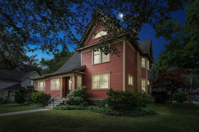 victorian home with a front lawn