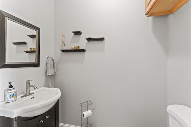 bathroom featuring vanity and toilet