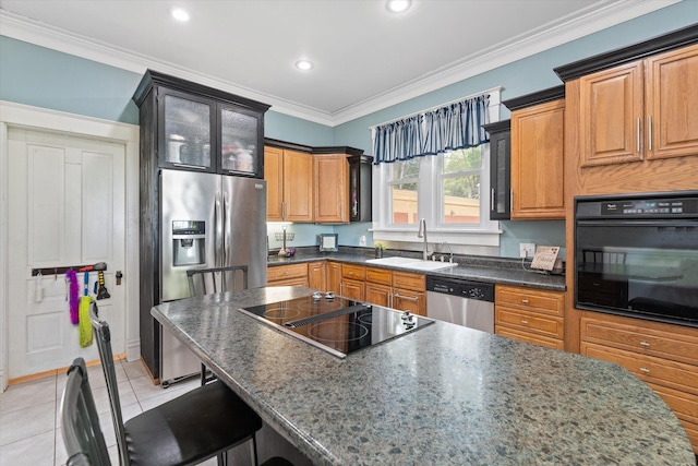 kitchen with crown molding, sink, black appliances, a breakfast bar area, and light tile patterned flooring