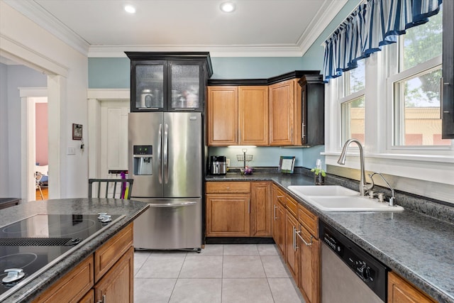 kitchen with crown molding, sink, dark stone countertops, light tile patterned floors, and appliances with stainless steel finishes