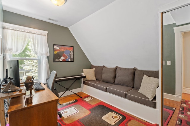 office area featuring hardwood / wood-style flooring and vaulted ceiling