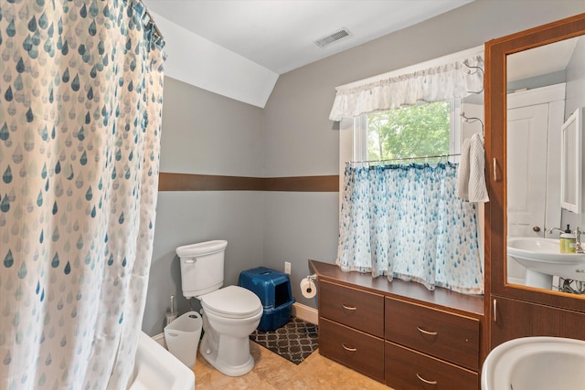 bathroom with sink, walk in shower, tile patterned flooring, vaulted ceiling, and toilet