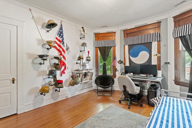 office space with hardwood / wood-style flooring and crown molding