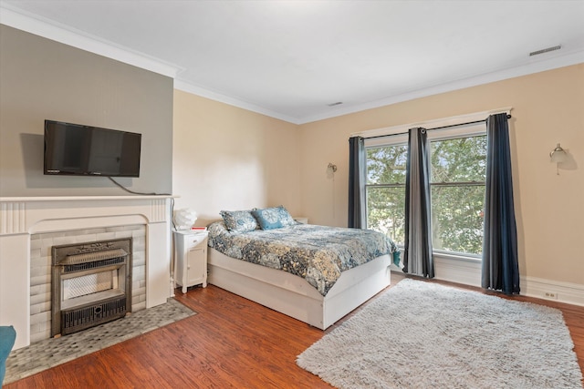 bedroom featuring hardwood / wood-style flooring and crown molding