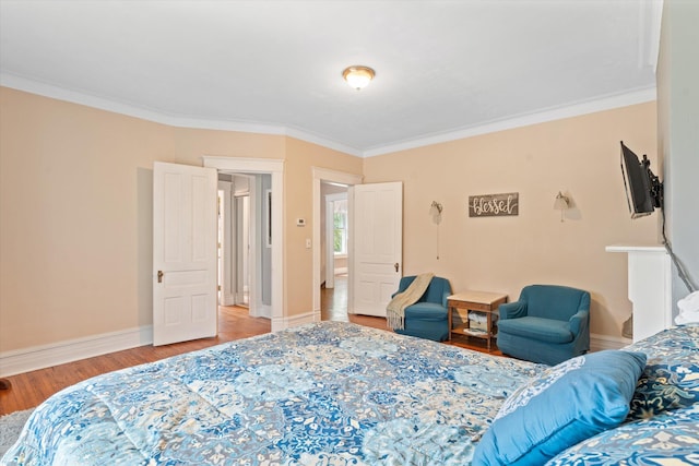 bedroom with hardwood / wood-style flooring and ornamental molding