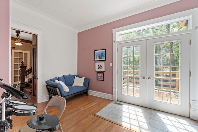 doorway to outside with french doors, light wood-type flooring, and crown molding