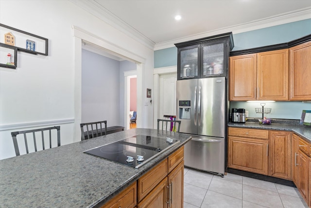 kitchen with stainless steel fridge, black electric stovetop, crown molding, and light tile patterned flooring