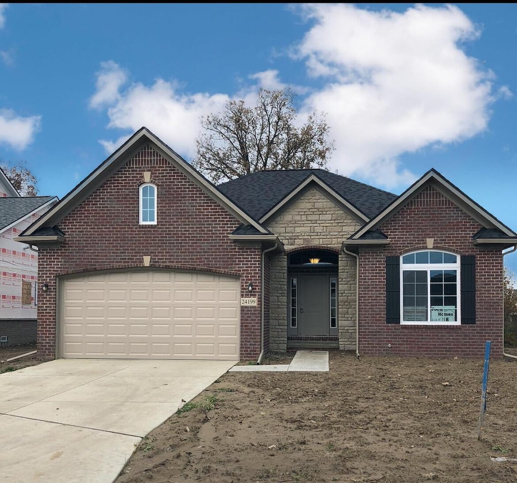 31612 Beaver Cir, New Boston, MI 48164 - view of front of house with stone siding, driveway, and brick siding