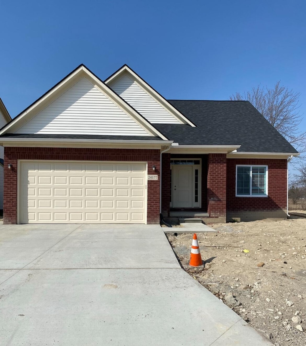 31608 Beaver Cir, New Boston, MI 48164 - view of front of house with brick siding, concrete driveway, an attached garage, and a shingled roof