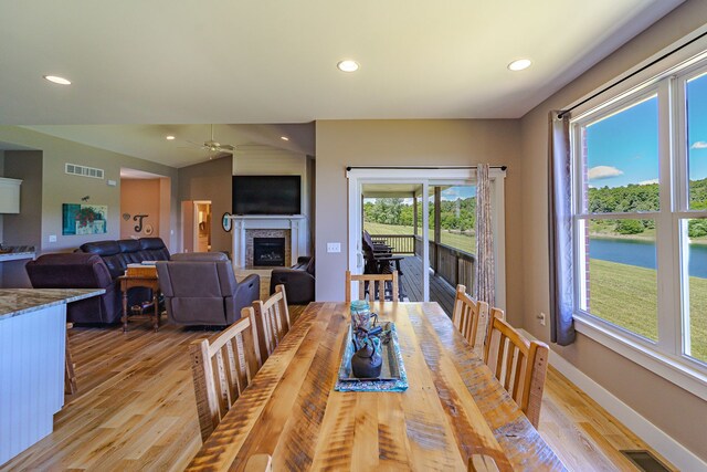 829 N Van Dyke Rd, Imlay City, MI 48444 - dining space with light wood-style flooring, a fireplace, a ceiling fan, recessed lighting, and baseboards