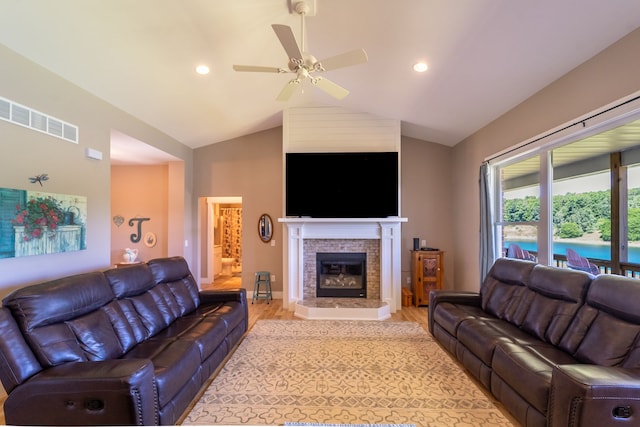 829 N Van Dyke Rd, Imlay City, MI 48444 - living room featuring light wood-style flooring, lofted ceiling, a ceiling fan, a glass covered fireplace, and recessed lighting
