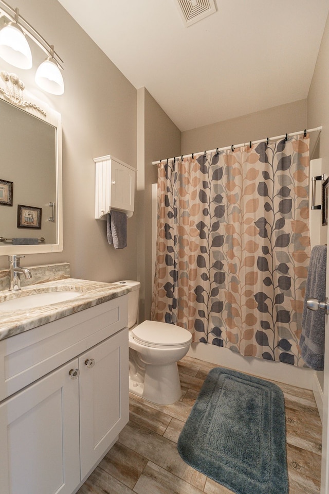 bathroom featuring hardwood / wood-style floors, vanity, and toilet