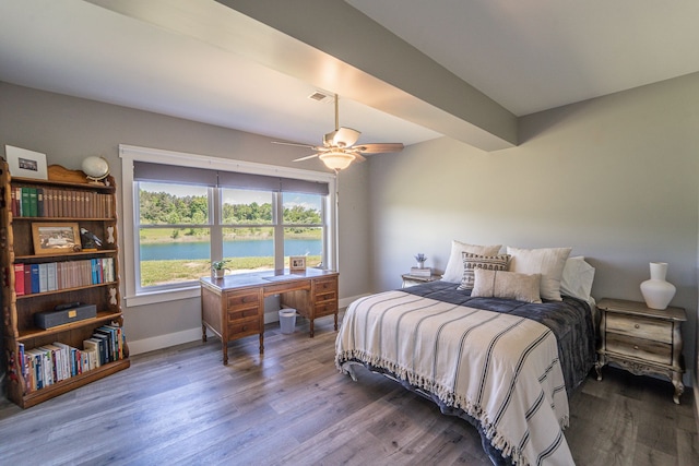 bedroom with ceiling fan, a water view, and hardwood / wood-style flooring