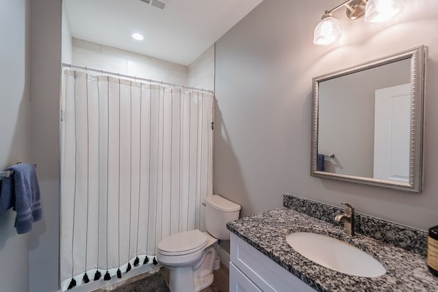 bathroom featuring a shower with curtain, vanity, and toilet