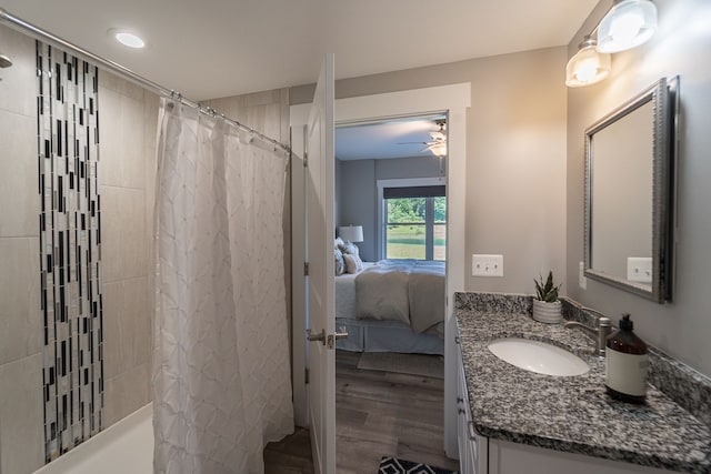 bathroom with hardwood / wood-style floors, vanity, and curtained shower