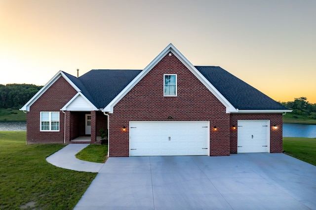 829 N Van Dyke Rd, Imlay City, MI 48444 - traditional-style home with a front yard, driveway, brick siding, a water view, and roof with shingles