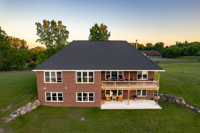 829 N Van Dyke Rd, Imlay City, MI 48444 - back of house featuring a patio, a lawn, brick siding, and a wooden deck