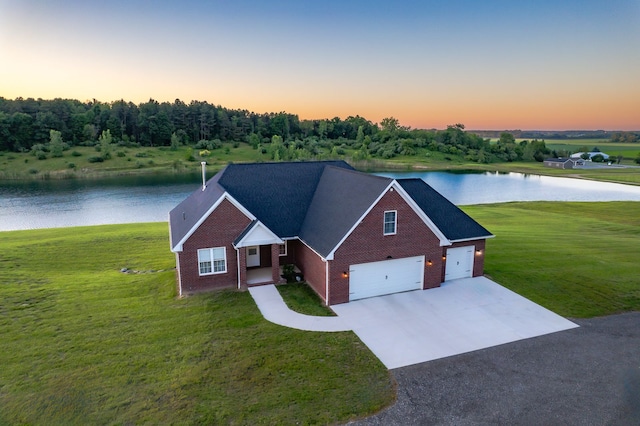 view of front facade with a yard and a water view