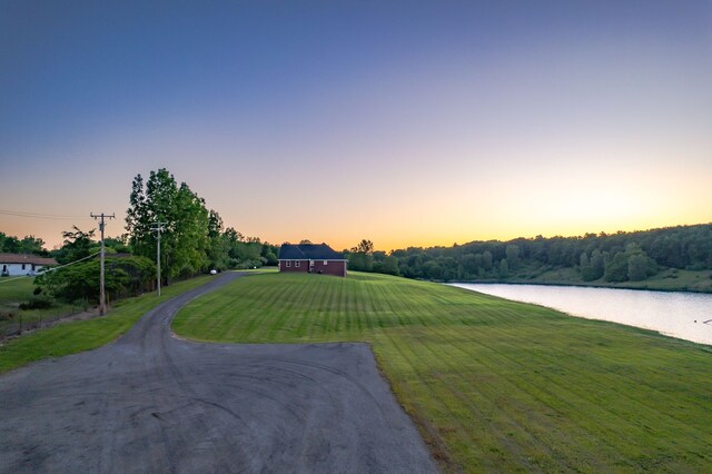 829 N Van Dyke Rd, Imlay City, MI 48444 - view of front facade with driveway, a lawn, and a water view