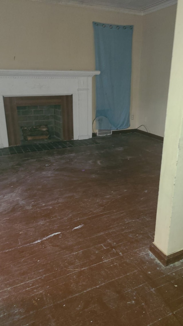 unfurnished living room with ornamental molding