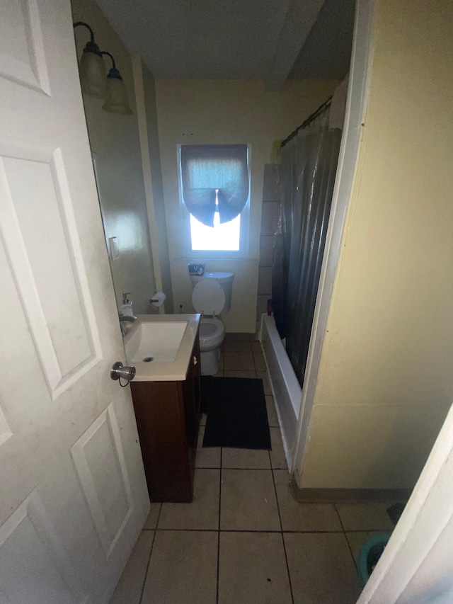 bathroom with tile patterned flooring, vanity, toilet, and a shower with shower curtain