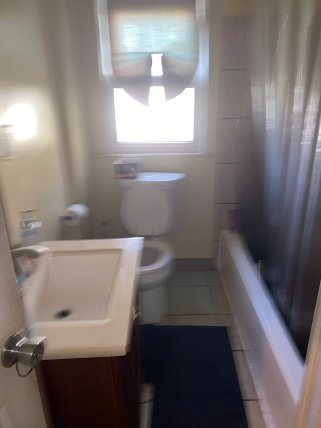 full bathroom featuring tile patterned floors, vanity, shower / bath combination with curtain, and toilet