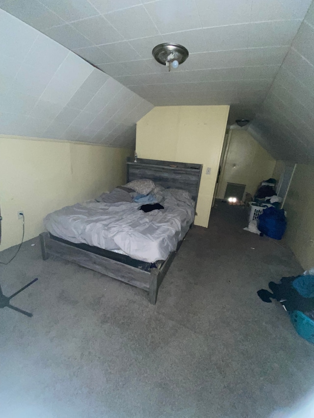 bedroom with carpet and lofted ceiling