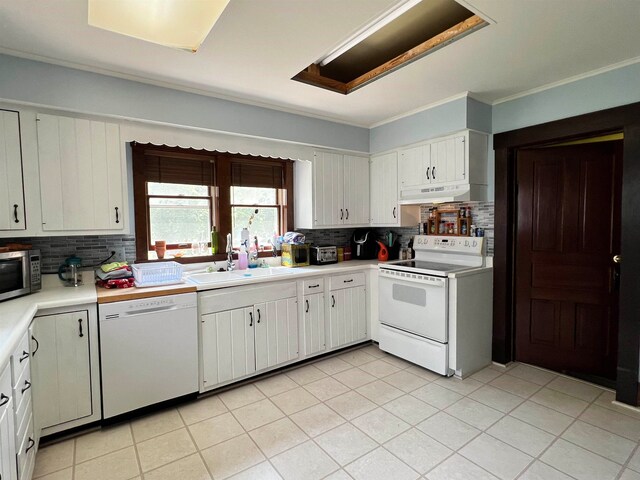 kitchen featuring decorative backsplash, white cabinetry, sink, and white appliances