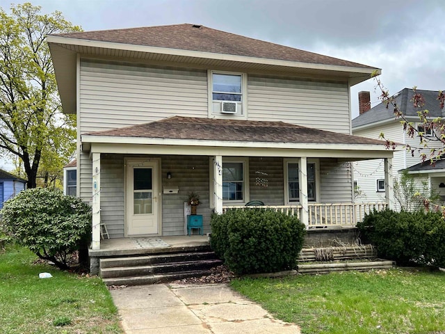 view of front facade with cooling unit and a porch