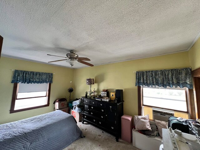 carpeted bedroom featuring a textured ceiling and ceiling fan