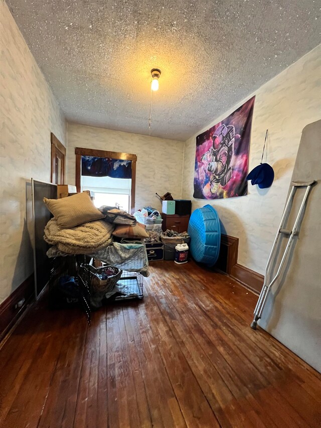 interior space featuring dark hardwood / wood-style floors and a textured ceiling