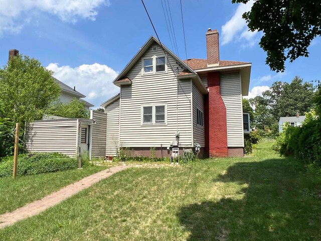 rear view of house with a lawn