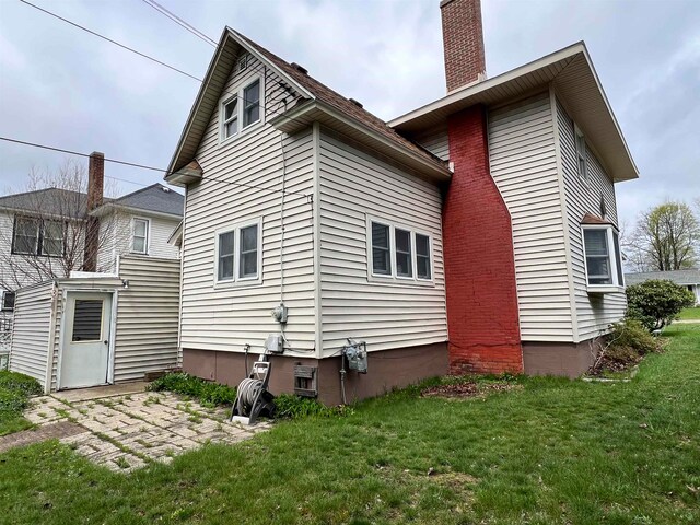 back of house with a yard