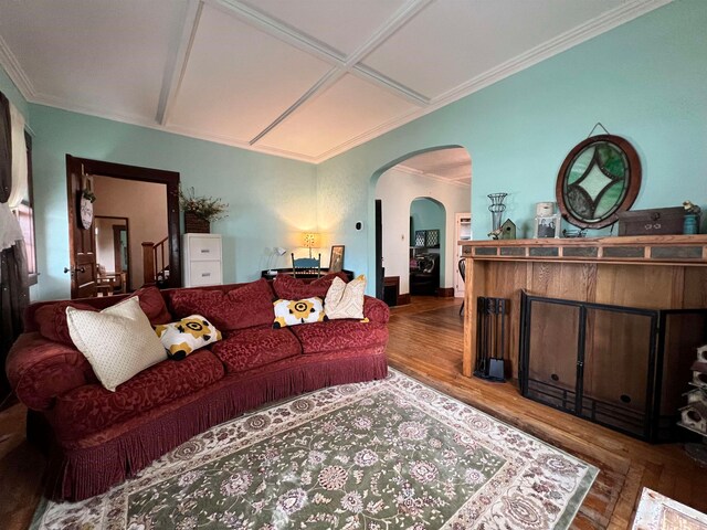 living room with hardwood / wood-style flooring, ornamental molding, and coffered ceiling