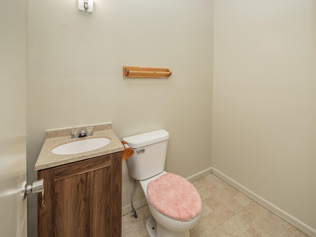 935 W Lovell St, Kalamazoo, MI 49007 - bathroom with vanity, toilet, and baseboards