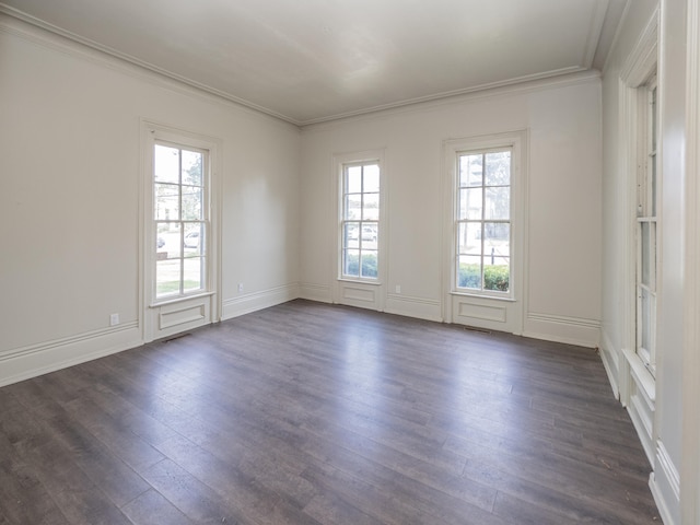 empty room featuring dark hardwood / wood-style floors and ornamental molding