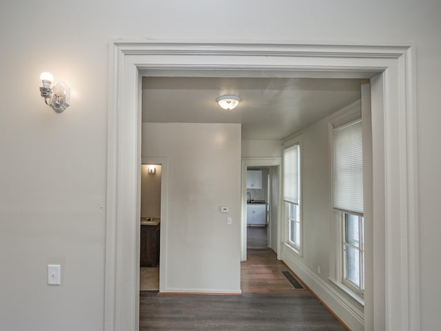 hall with dark wood-type flooring