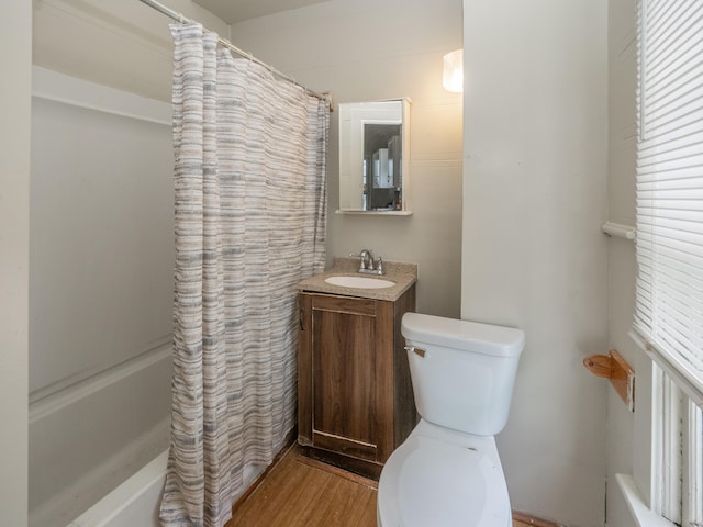 full bathroom with hardwood / wood-style floors, vanity, toilet, and a wealth of natural light