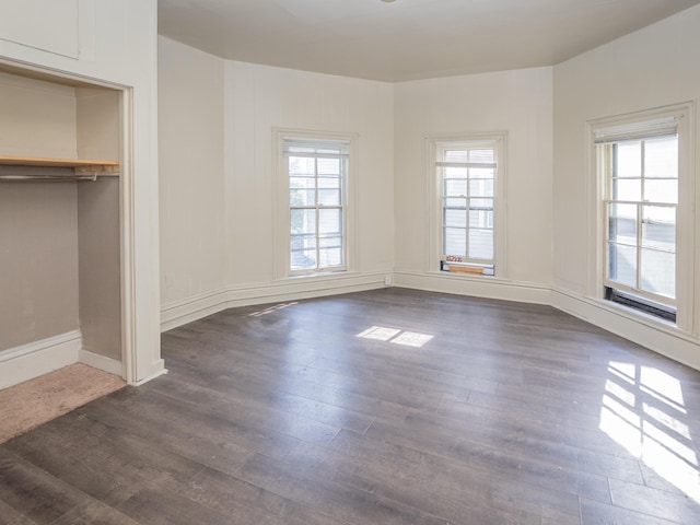 unfurnished bedroom featuring a closet and dark hardwood / wood-style floors