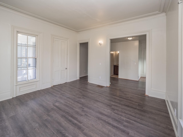 unfurnished room with crown molding and dark hardwood / wood-style floors