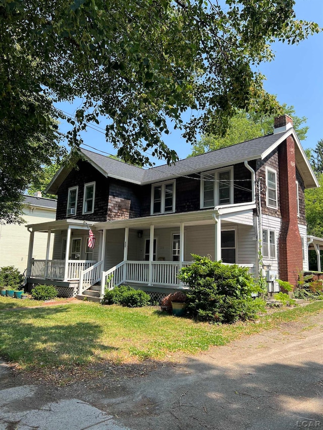 view of front of home with a front lawn and a porch