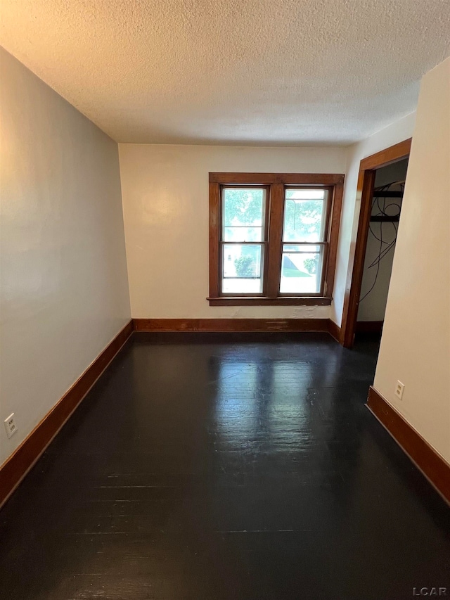 empty room with a textured ceiling