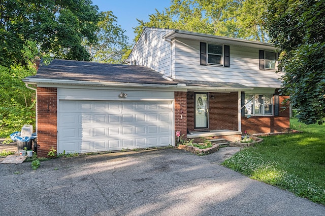 front facade featuring a front yard and a garage