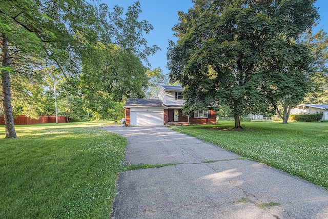 view of front of house featuring a garage and a front lawn