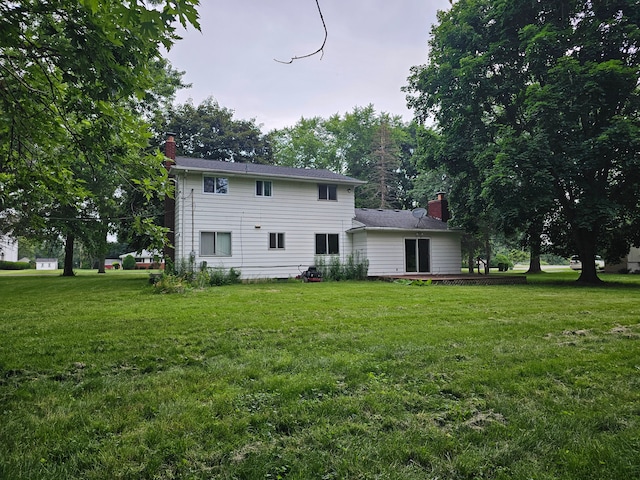 rear view of house with a yard