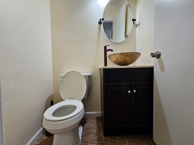 bathroom featuring tile patterned flooring, vanity, and toilet