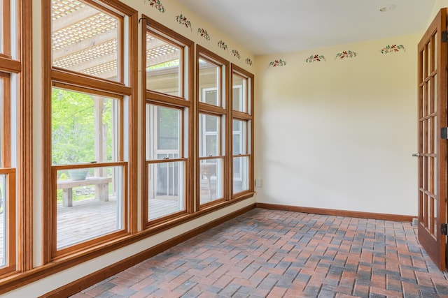1477 E Hastings Lake Rd, Jonesville, MI 49250 - unfurnished room with baseboards and brick floors