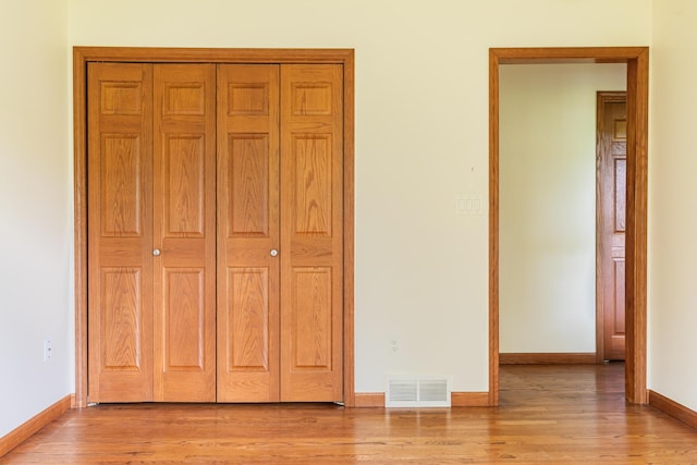 1477 E Hastings Lake Rd, Jonesville, MI 49250 - unfurnished bedroom with baseboards, light wood-style flooring, and a closet