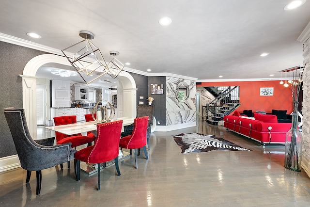 dining space with a chandelier and crown molding