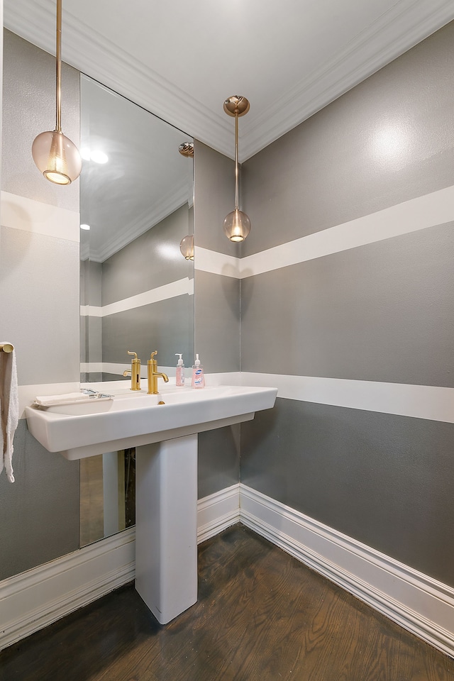 bathroom with hardwood / wood-style floors and ornamental molding